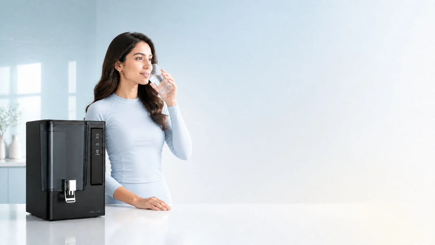 Ralla water purifier campaign with a woman drinking a glass of water