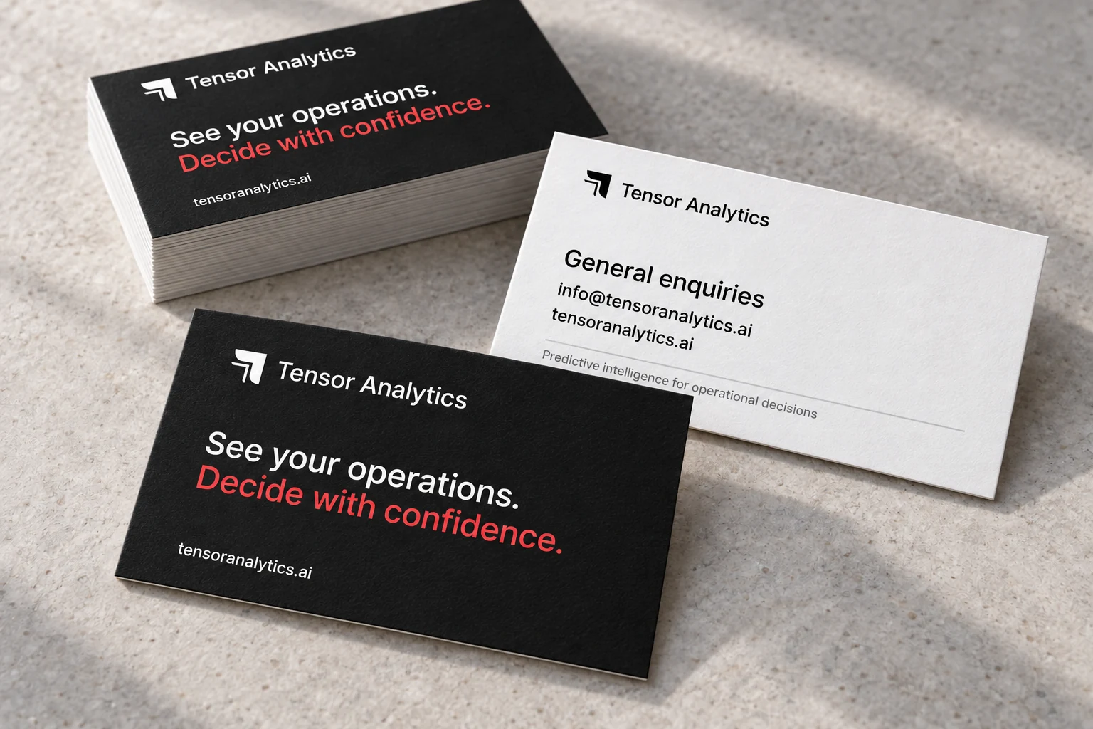 Tensor Analytics identity on black and white business cards with signal red accents